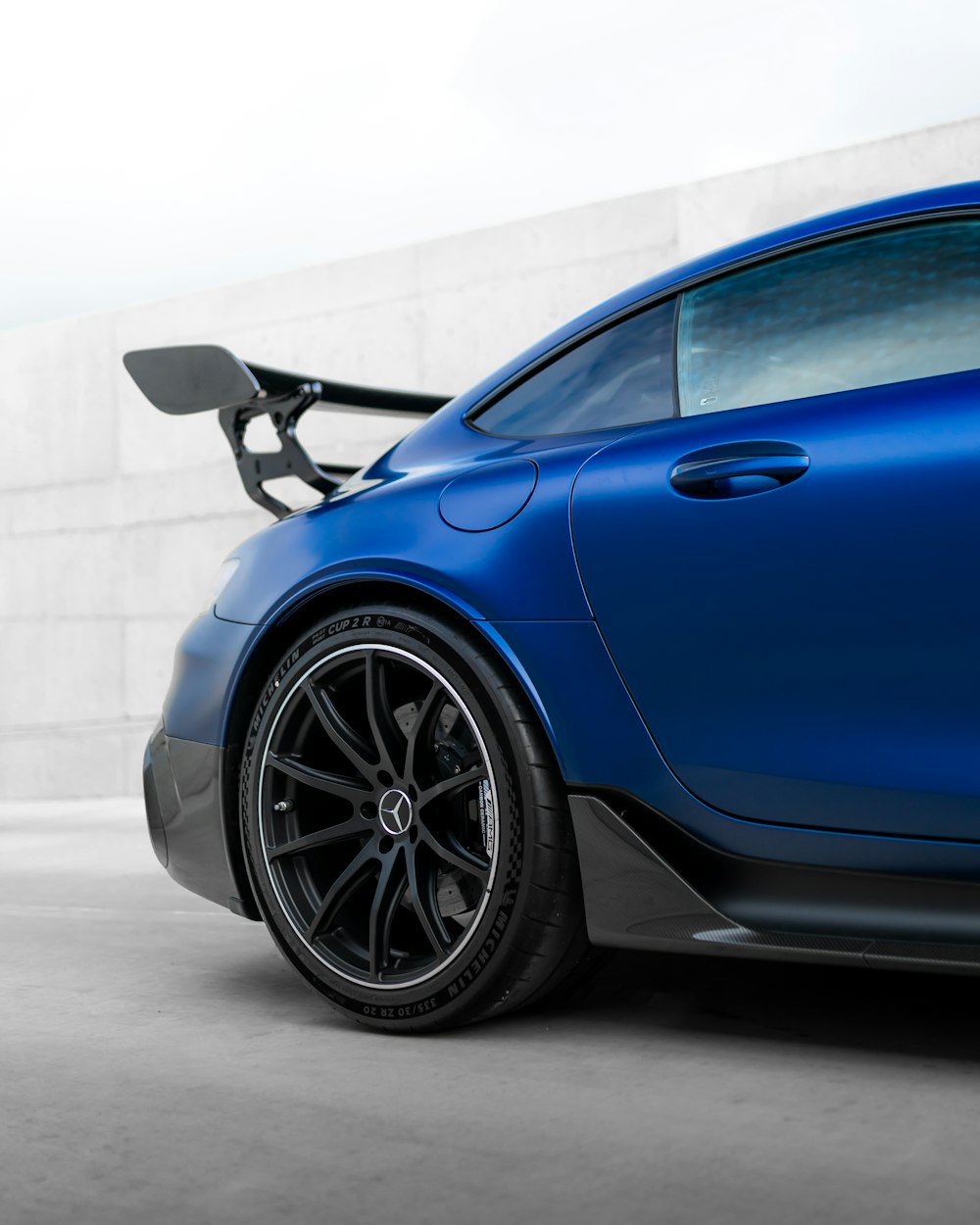 blue car parked on gray concrete floor