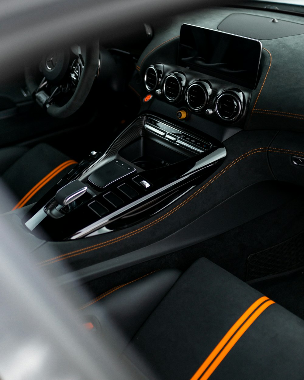 black and orange car steering wheel