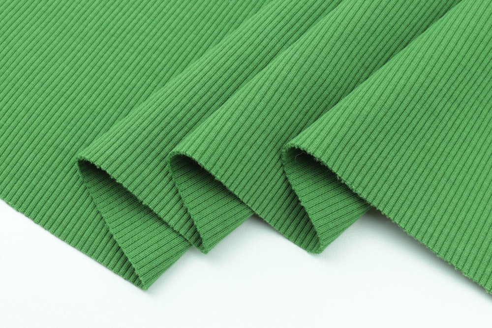 green textile on white surface