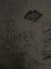 Raw canvas with splattered paint and visible pencil sketches beneath.