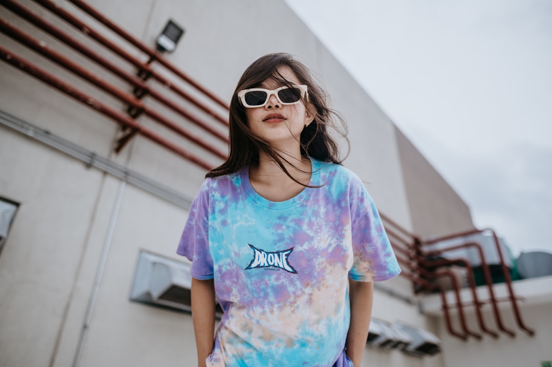 girl in purple and blue crew neck t-shirt wearing brown sunglasses