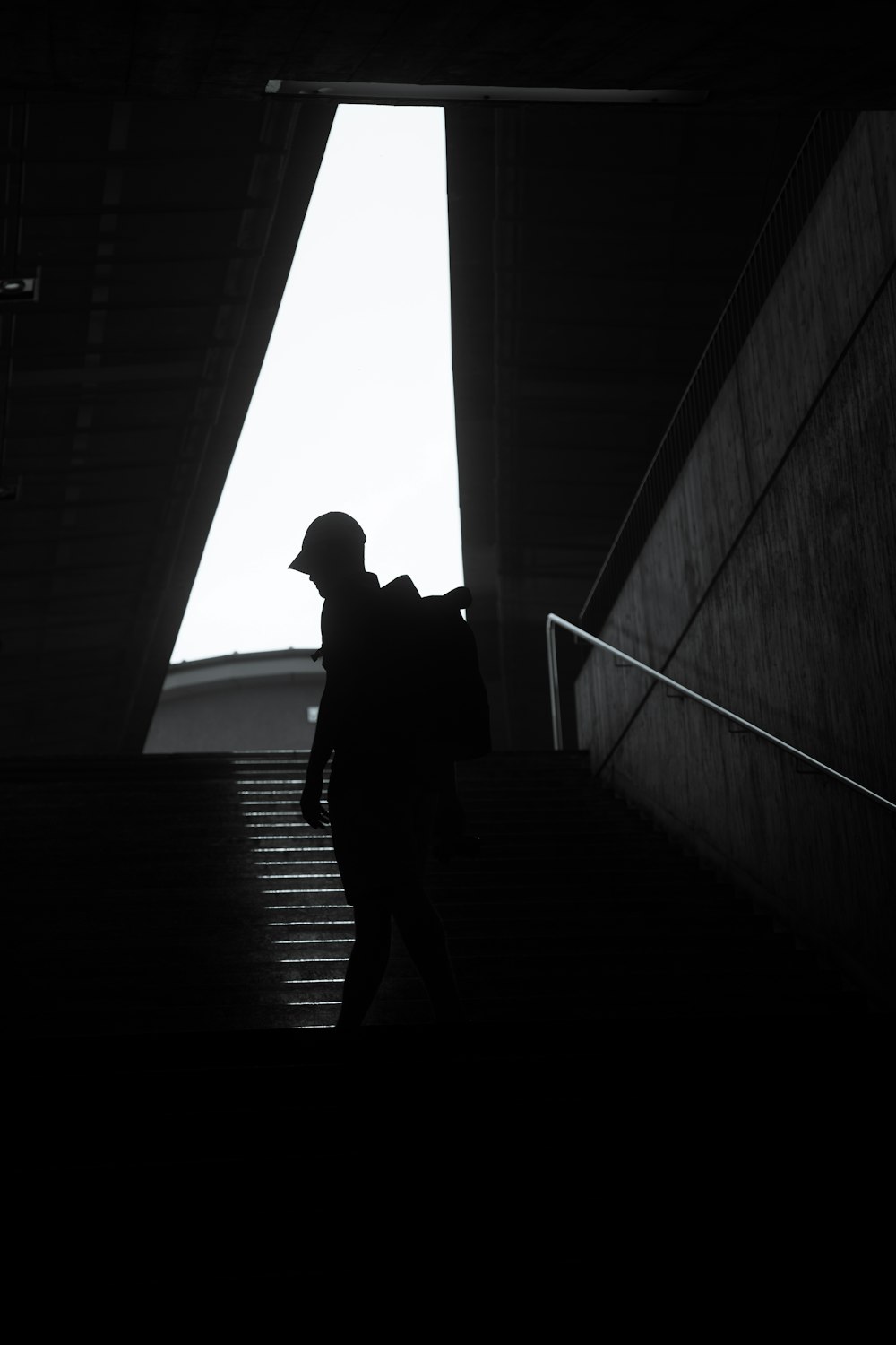 silhouette of man sitting on stairs