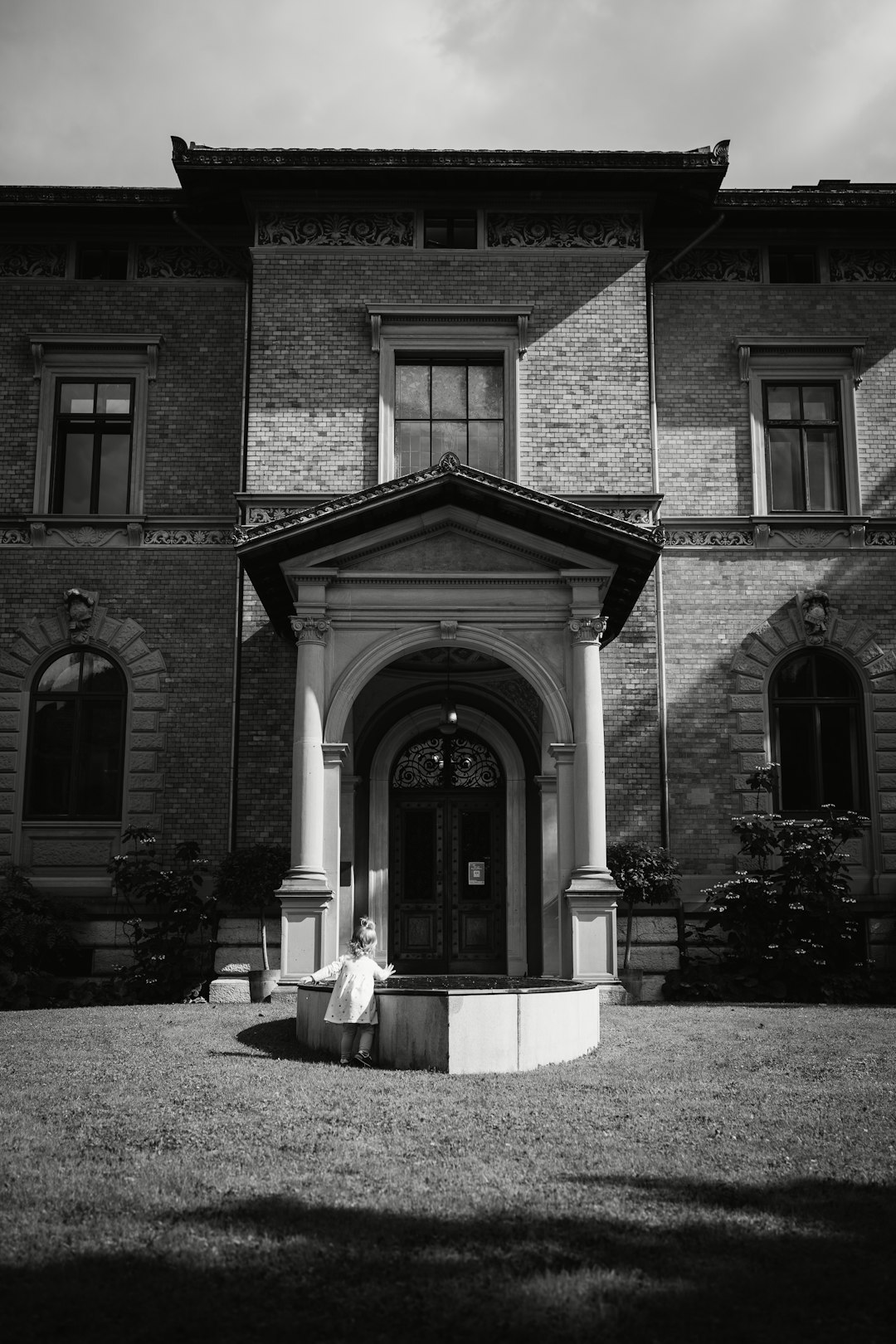 grayscale photo of brick building