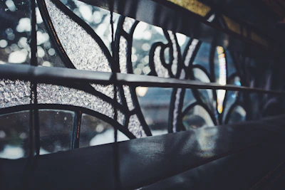 Close-up of a craftsman carefully painting a colorful stained glass panel.