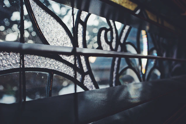 Close-up of a colorful handcrafted stained glass window glowing with natural light.