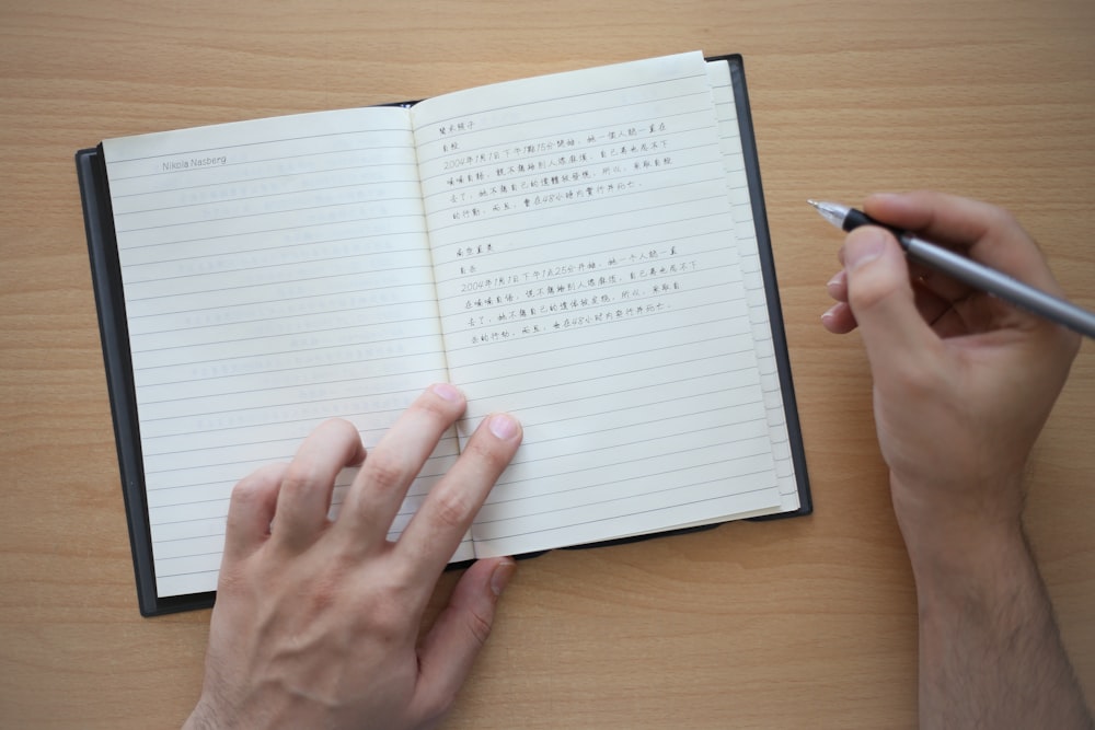 person holding white ruled paper