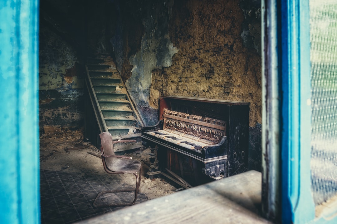 brown wooden bench beside brown wooden upright piano