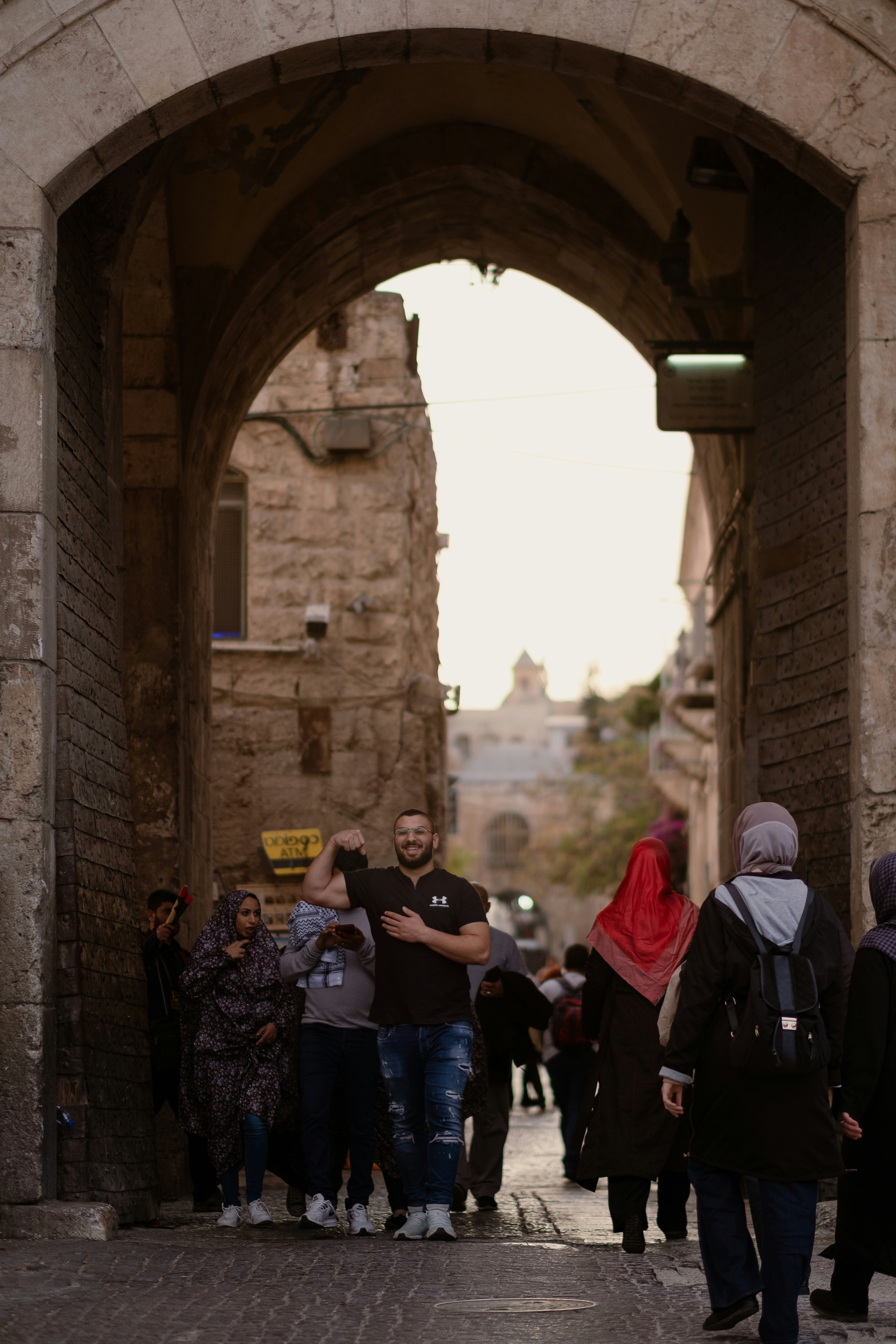 people standing near brown brick building during daytime