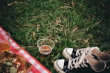 A picnic scene showing eco cups alongside healthy snacks and a blanket.