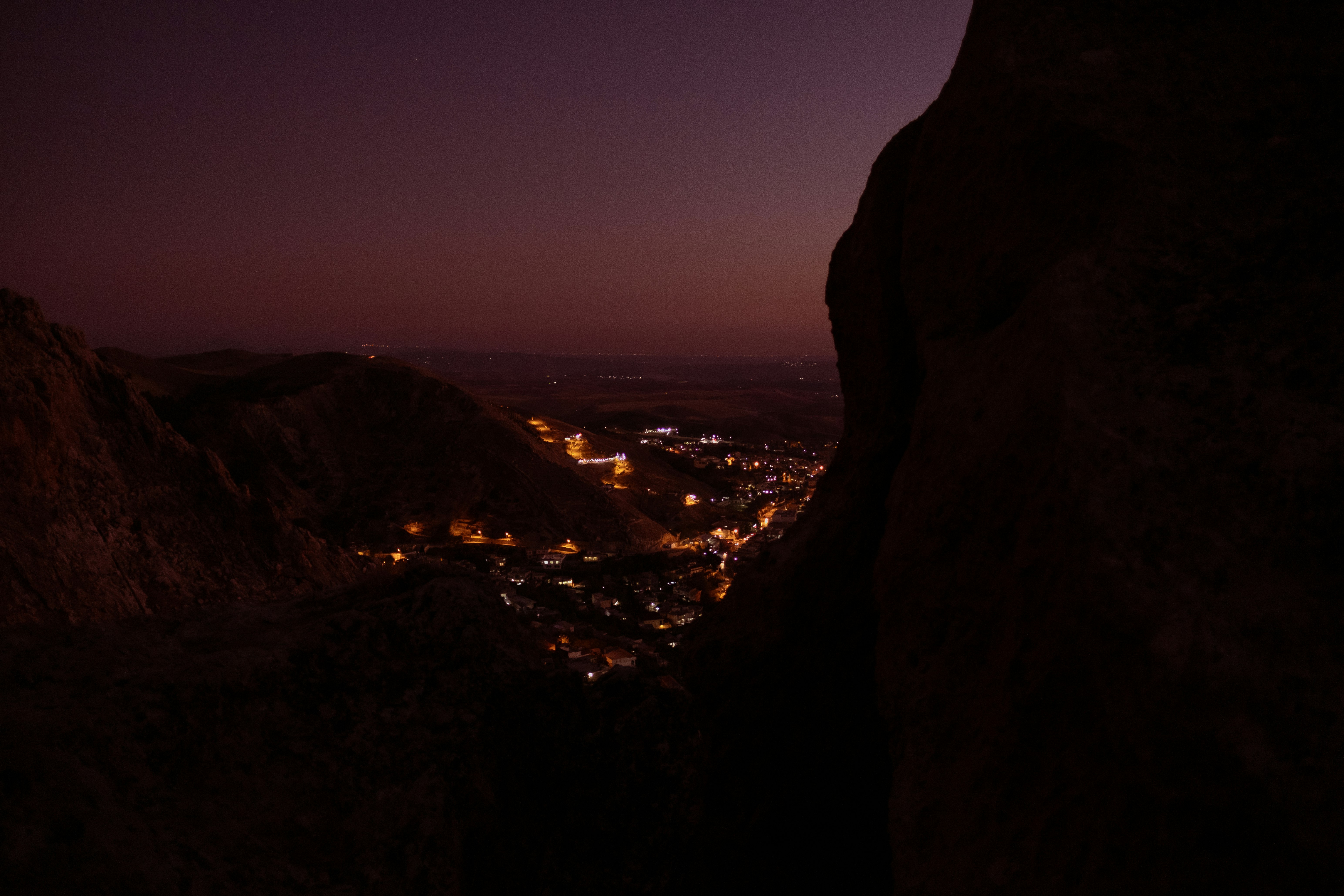 silhouette of mountain during night time