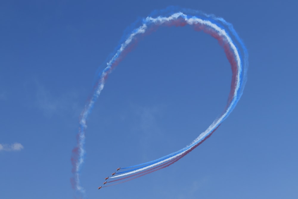 white and orange smoke under blue sky during daytime