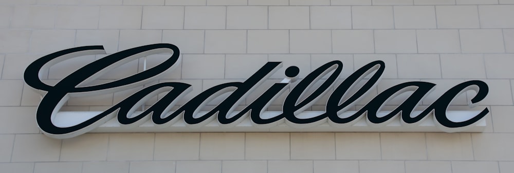 a sign on the side of a building that says cadillac