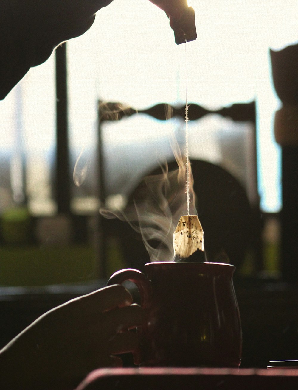 water pouring from black ceramic mug