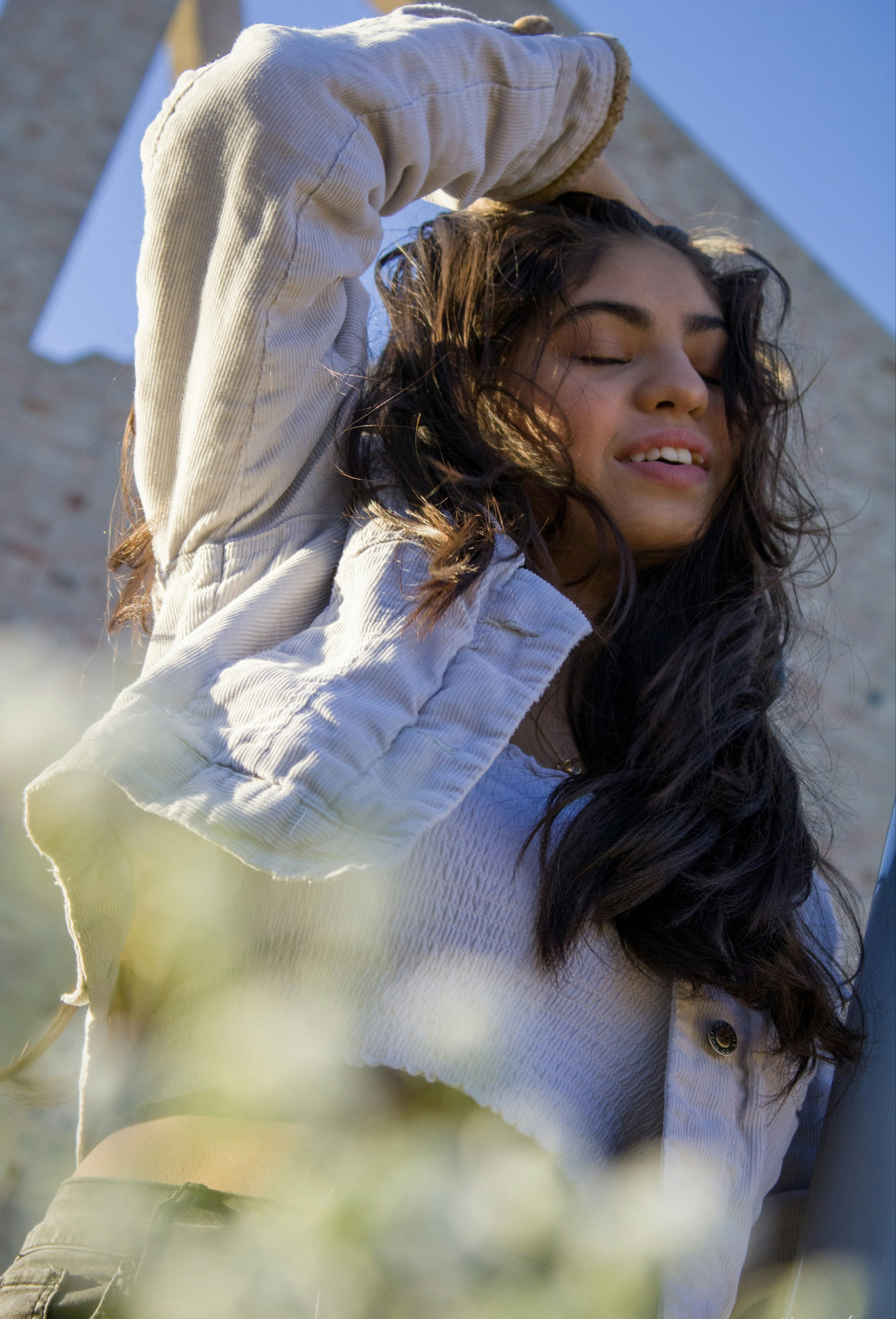 woman in white long sleeve shirt smiling