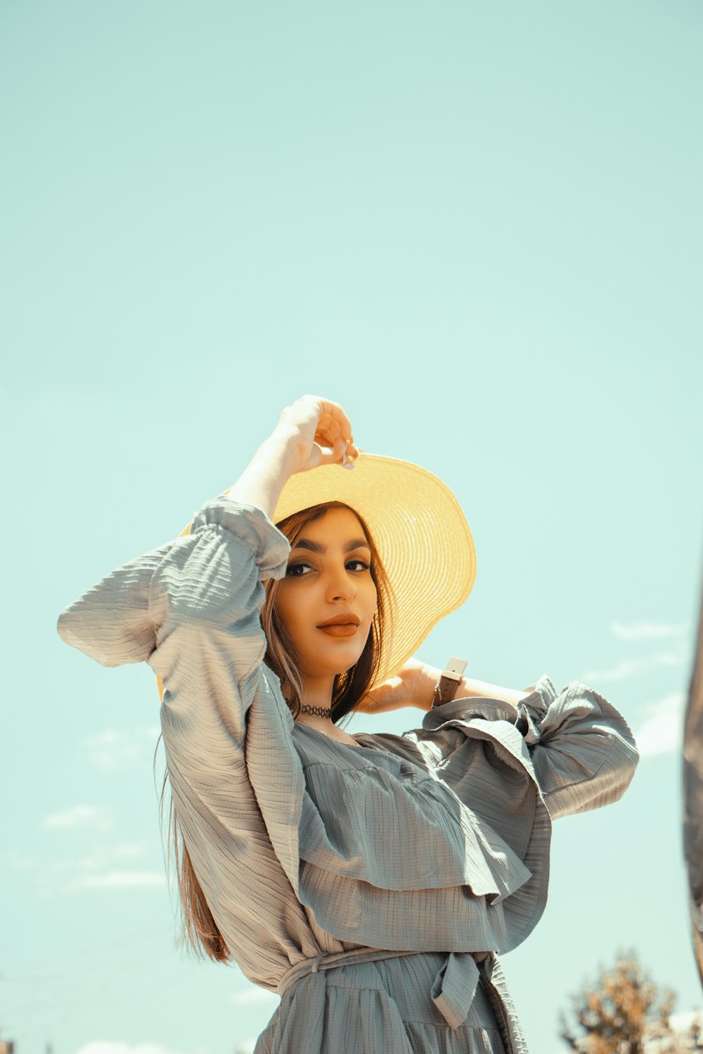 a woman wearing a hat and a dress