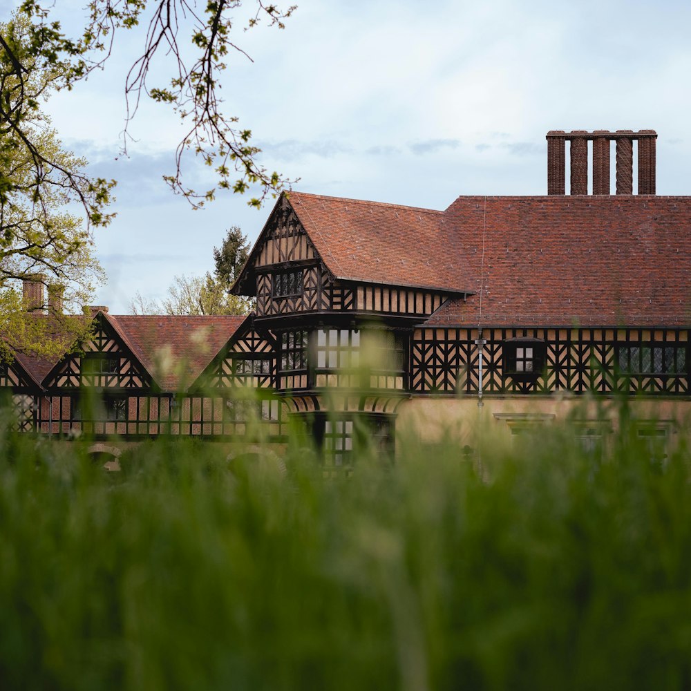 brown and black house near green grass field during daytime