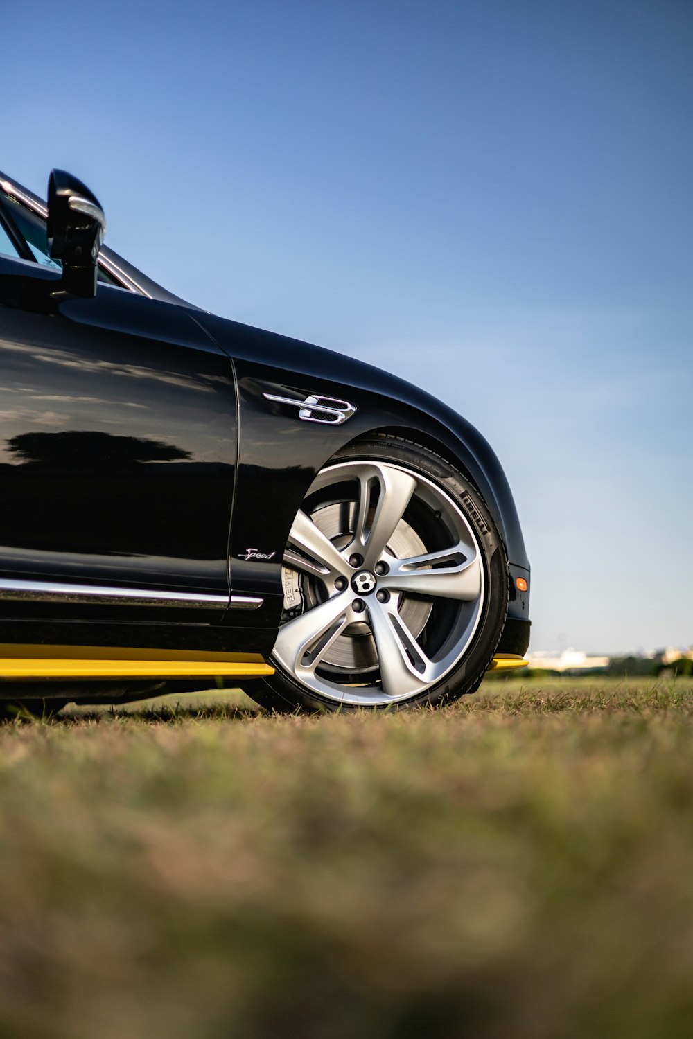 black car on green grass field during daytime