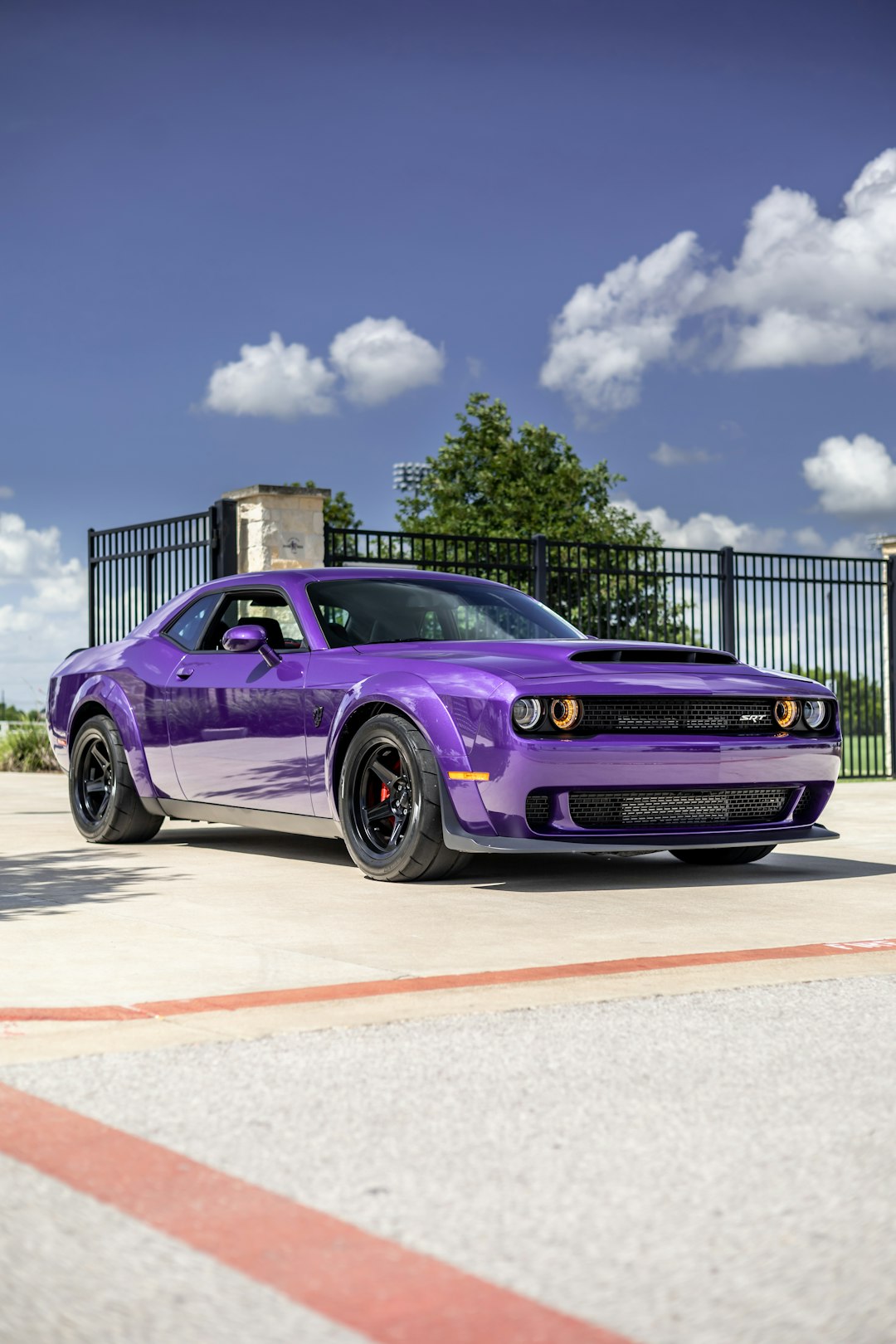 purple chevrolet camaro on road during daytime