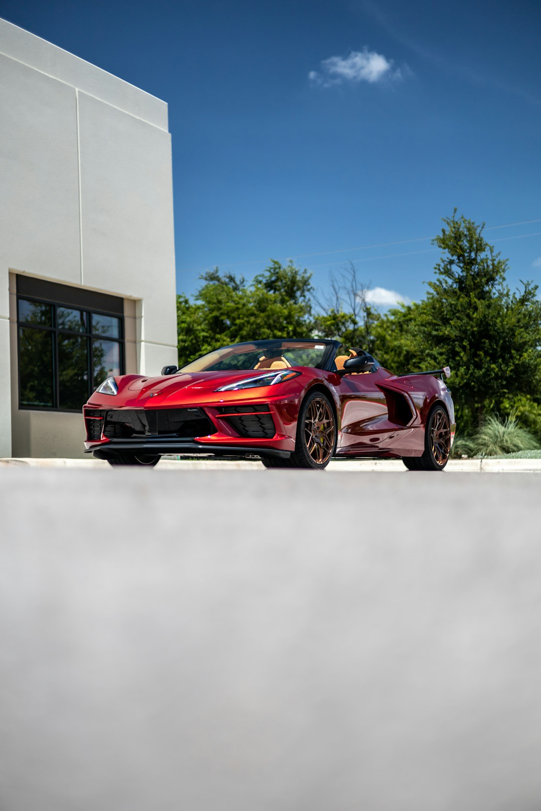 red ferrari 458 italia parked near white building