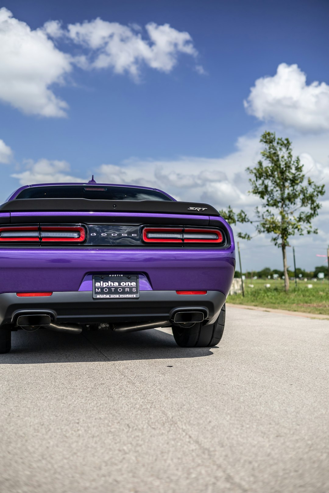 purple chevrolet car on road during daytime