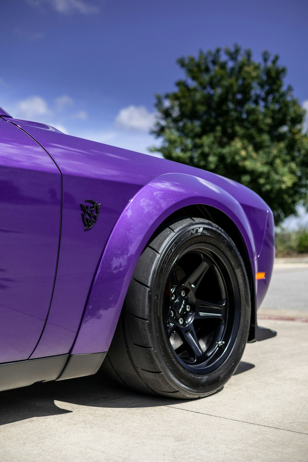 purple car on gray asphalt road during daytime