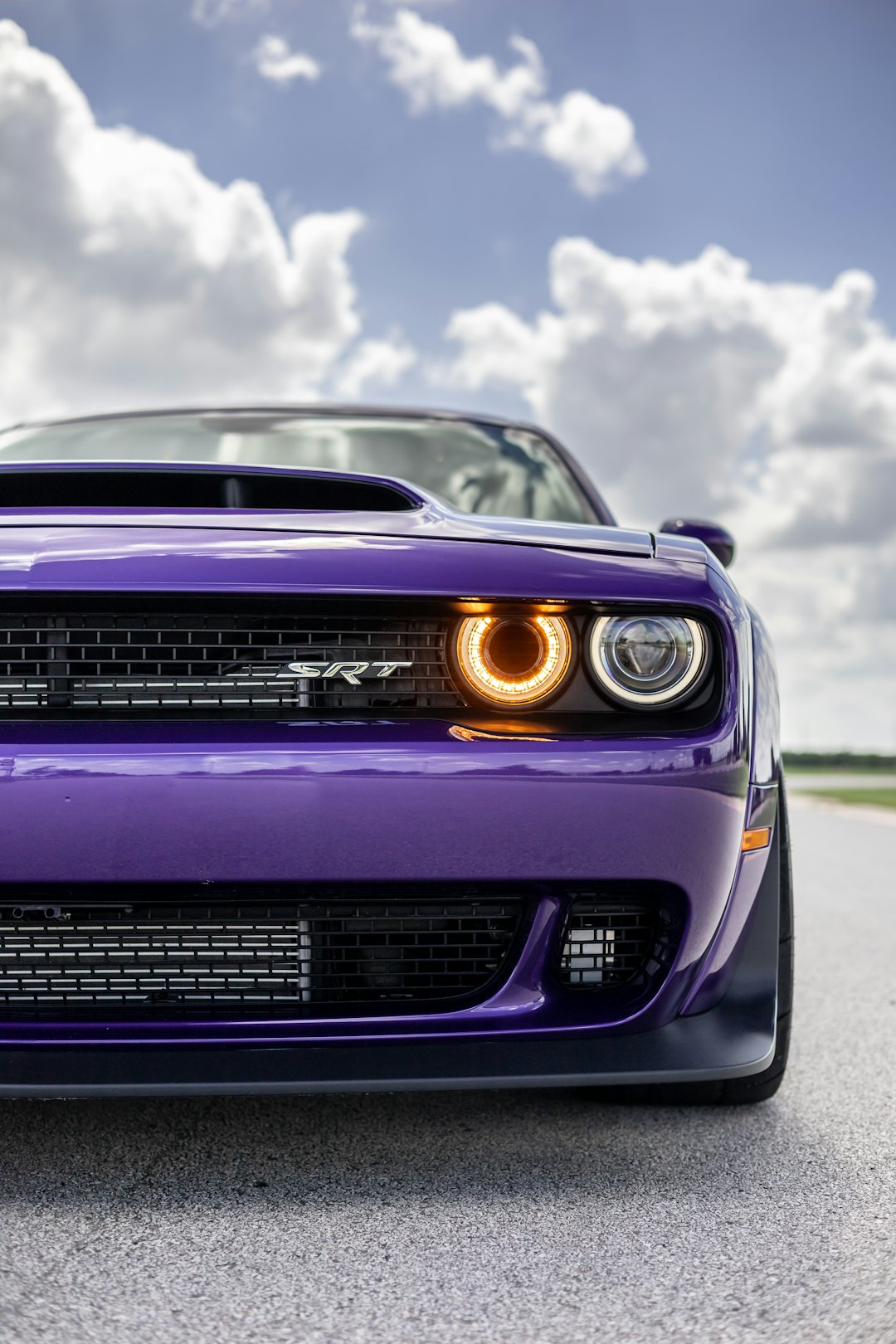 purple chevrolet camaro on road during daytime