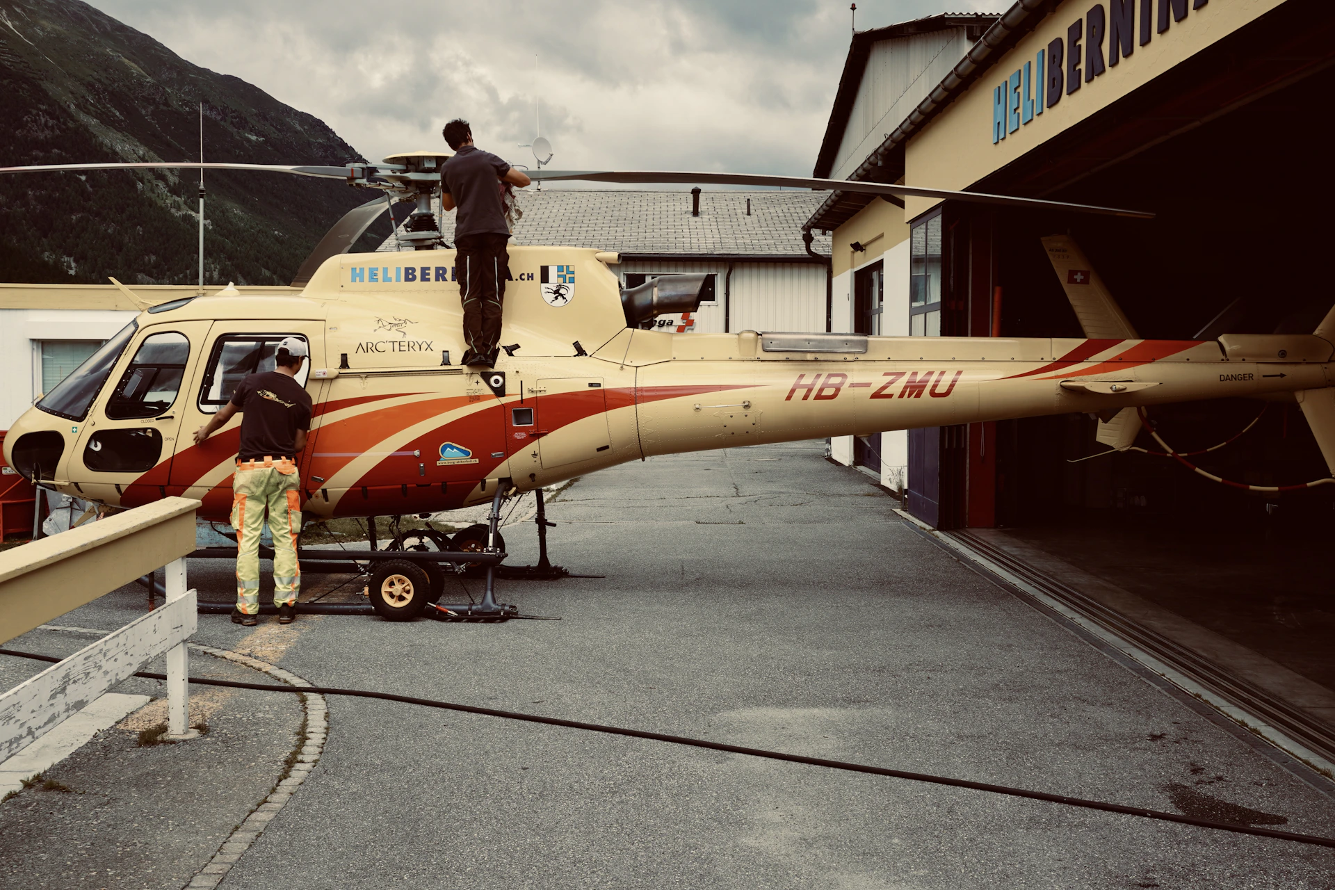 woman in red and white dress standing beside yellow and red airplane during daytime