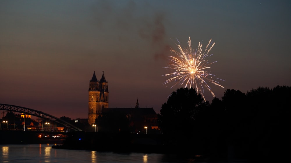 fireworks display over brown concrete building during night time