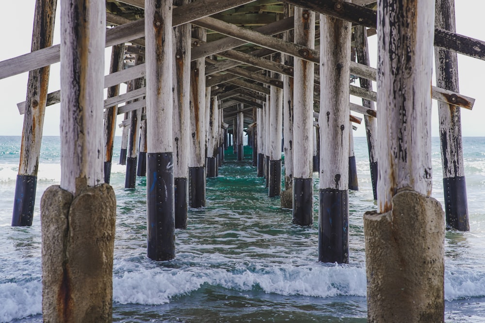 brown wooden dock on body of water during daytime