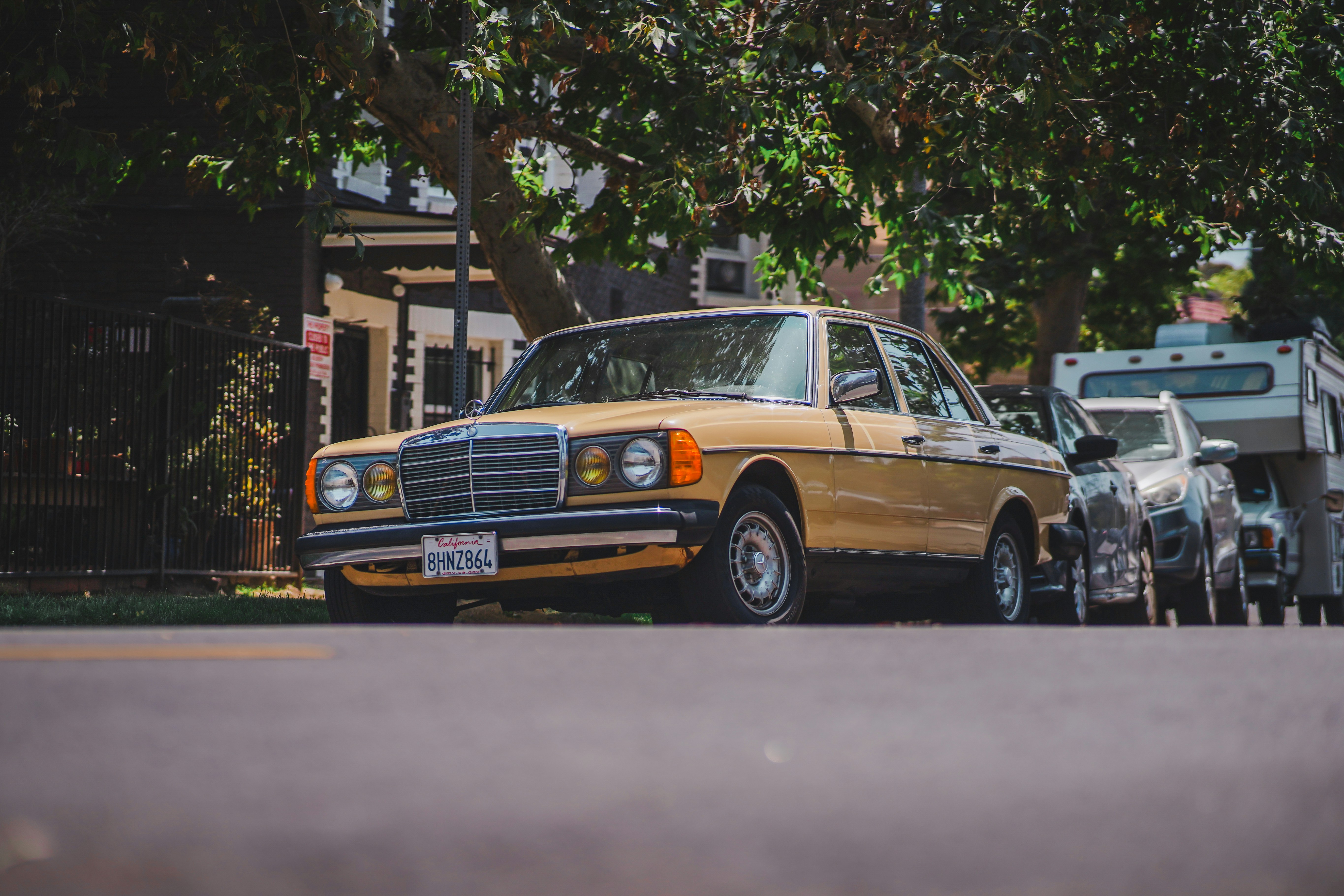 brown sedan on road during daytime