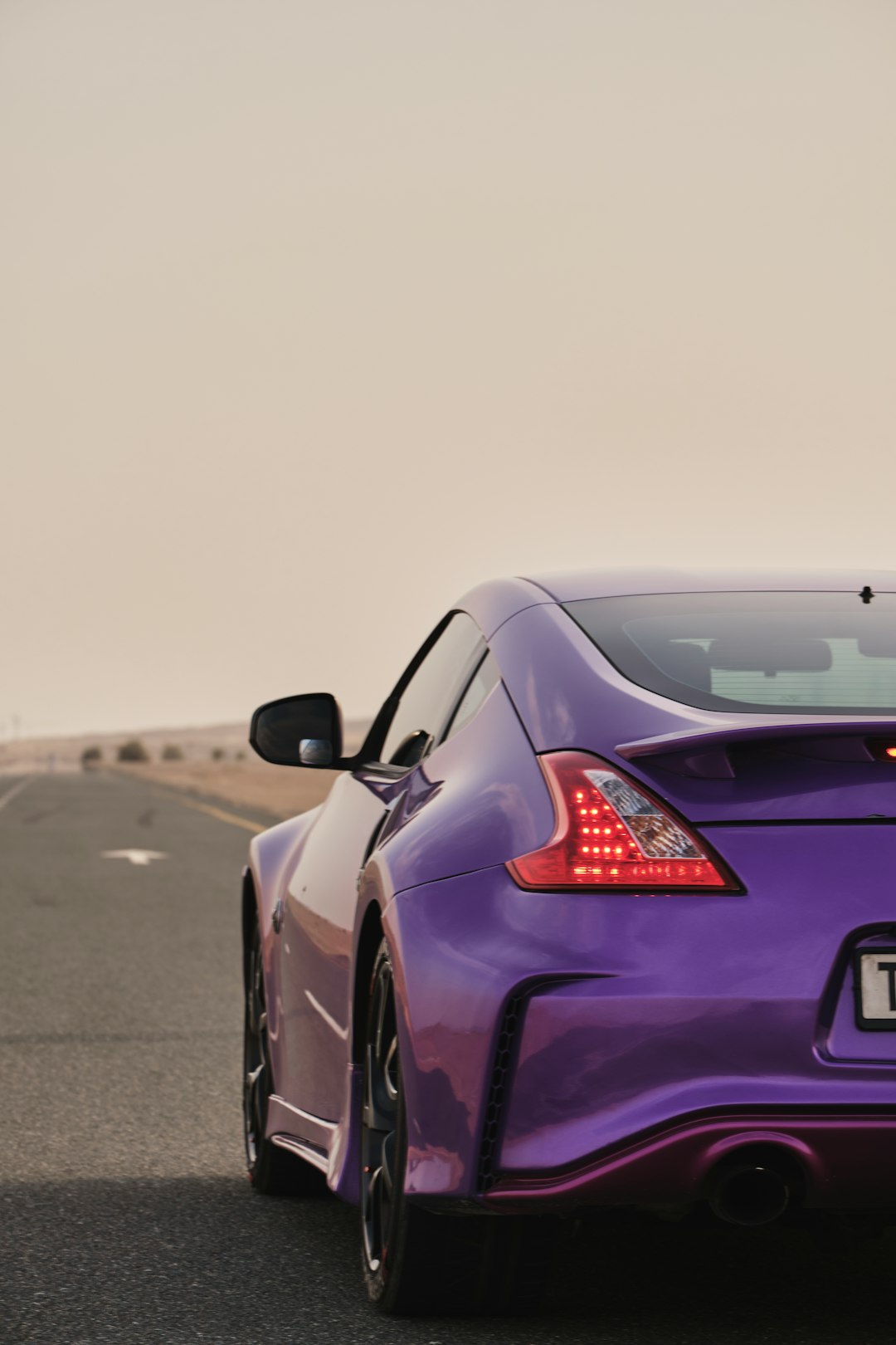 purple car on gray asphalt road during daytime