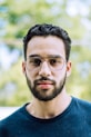man in blue crew neck shirt wearing black framed eyeglasses