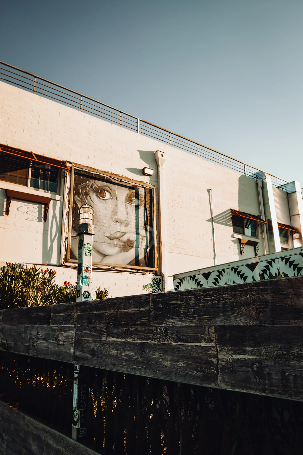 A large monochrome portrait mural on a low building in the Las Vegas Arts District