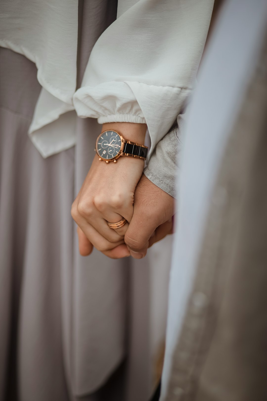 person wearing gold and black analog watch