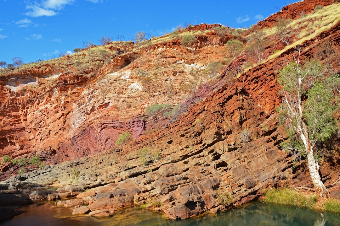 brown rock formation beside river during daytime
