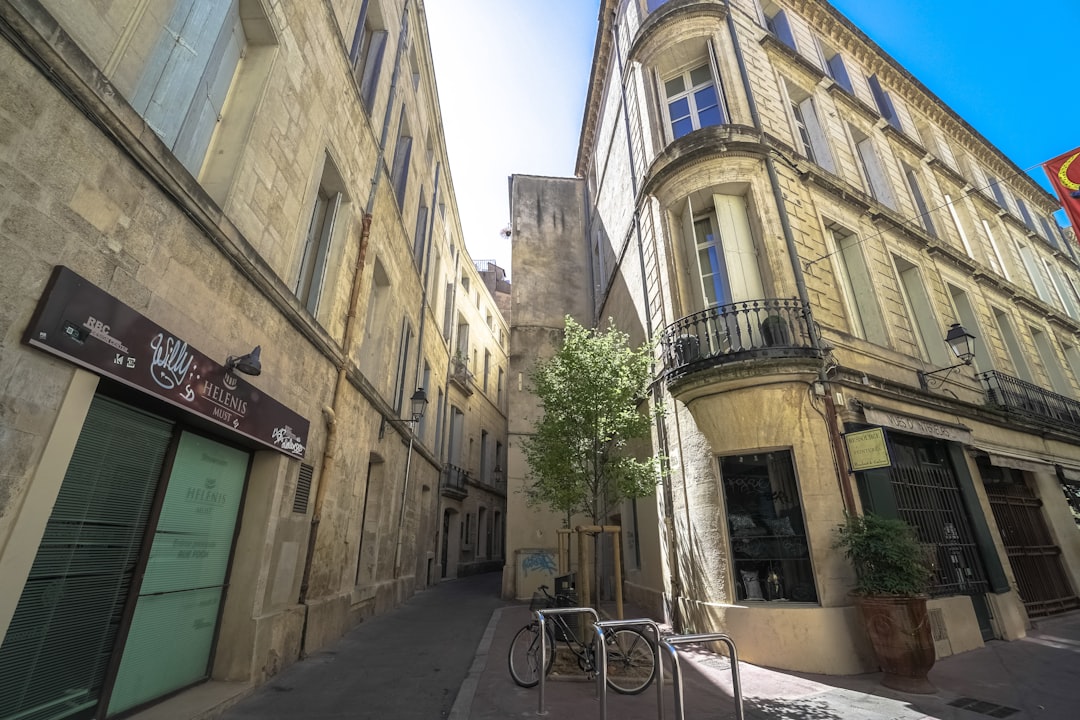 black bicycle parked beside brown concrete building during daytime