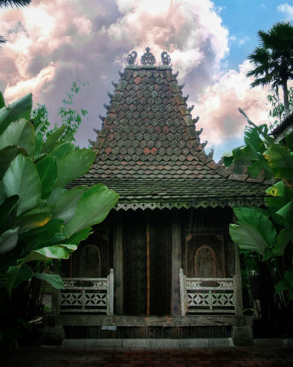 brown and gray concrete building under blue sky and white clouds during daytime