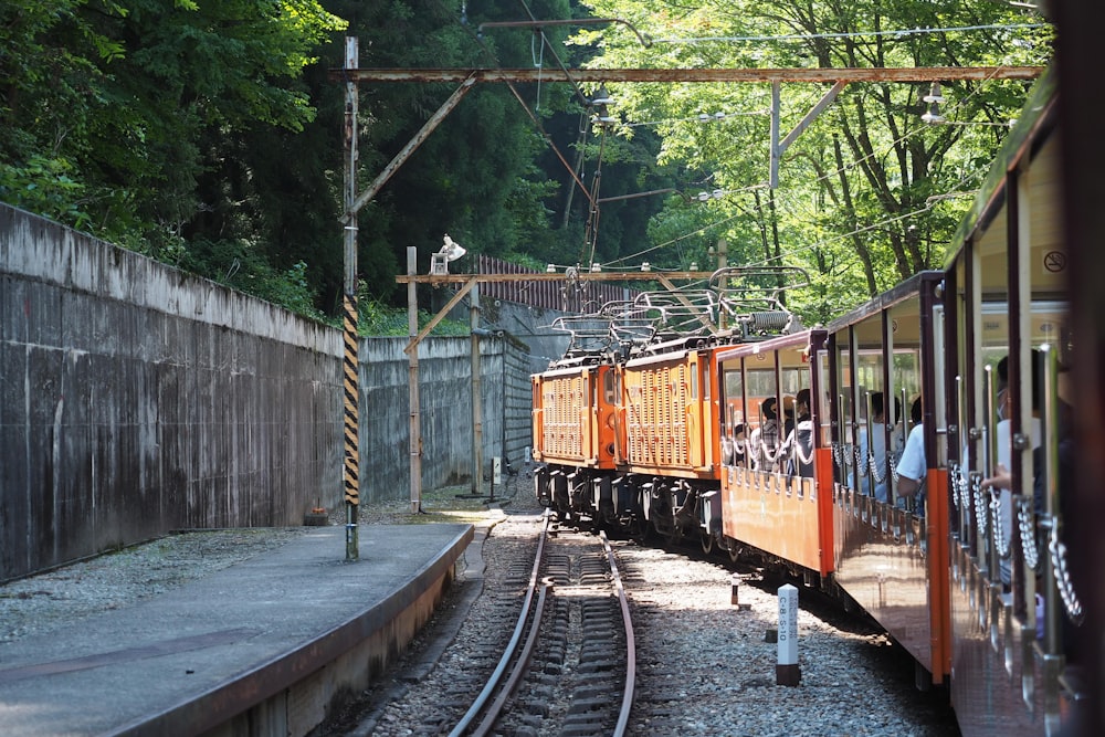 yellow and black train on rail tracks during daytime