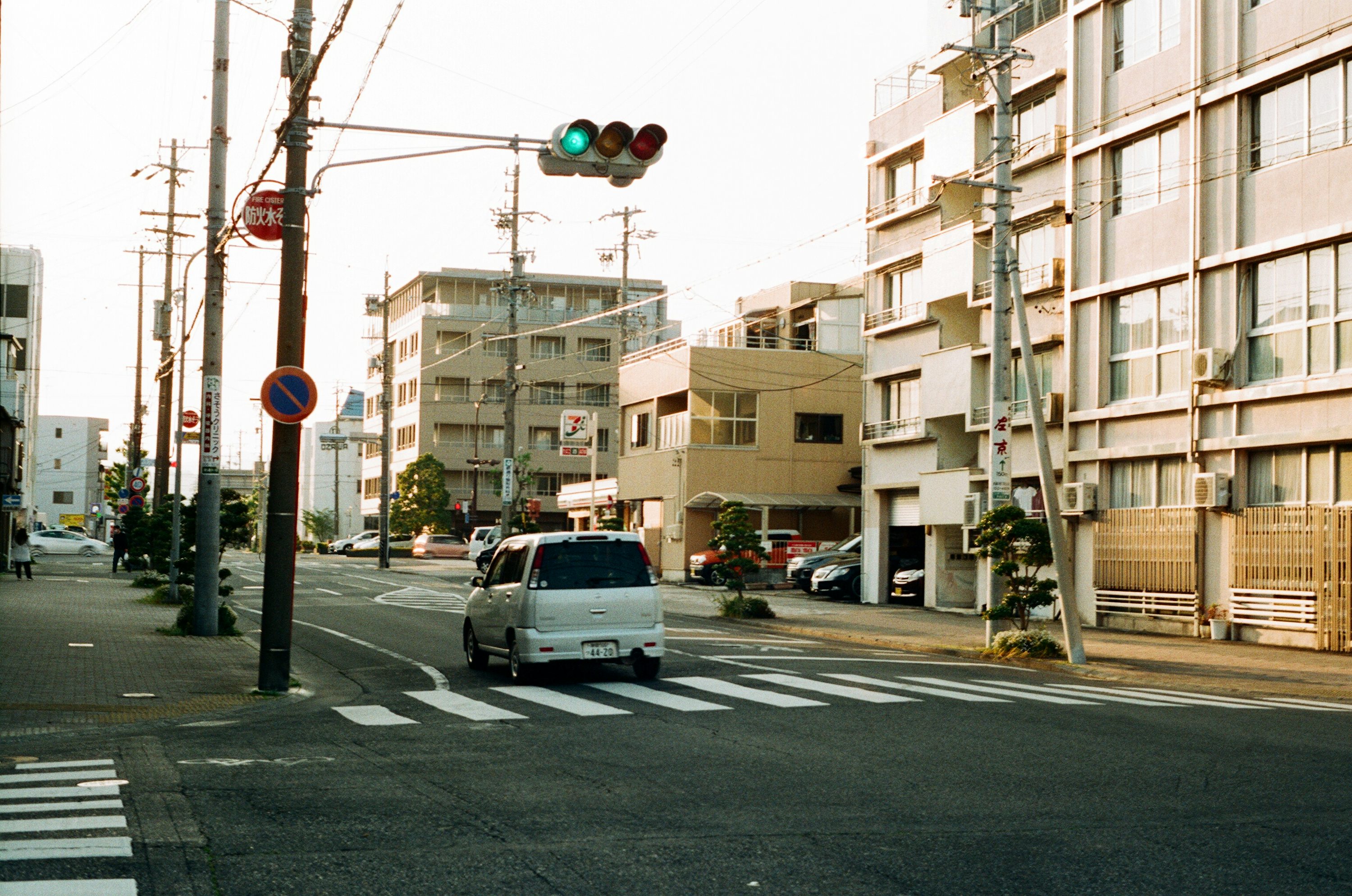 white car on road near traffic light during daytime