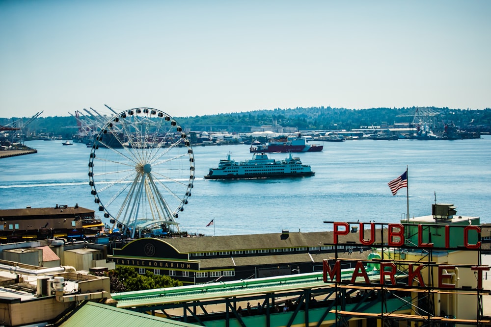 ferris wheel near body of water during daytime