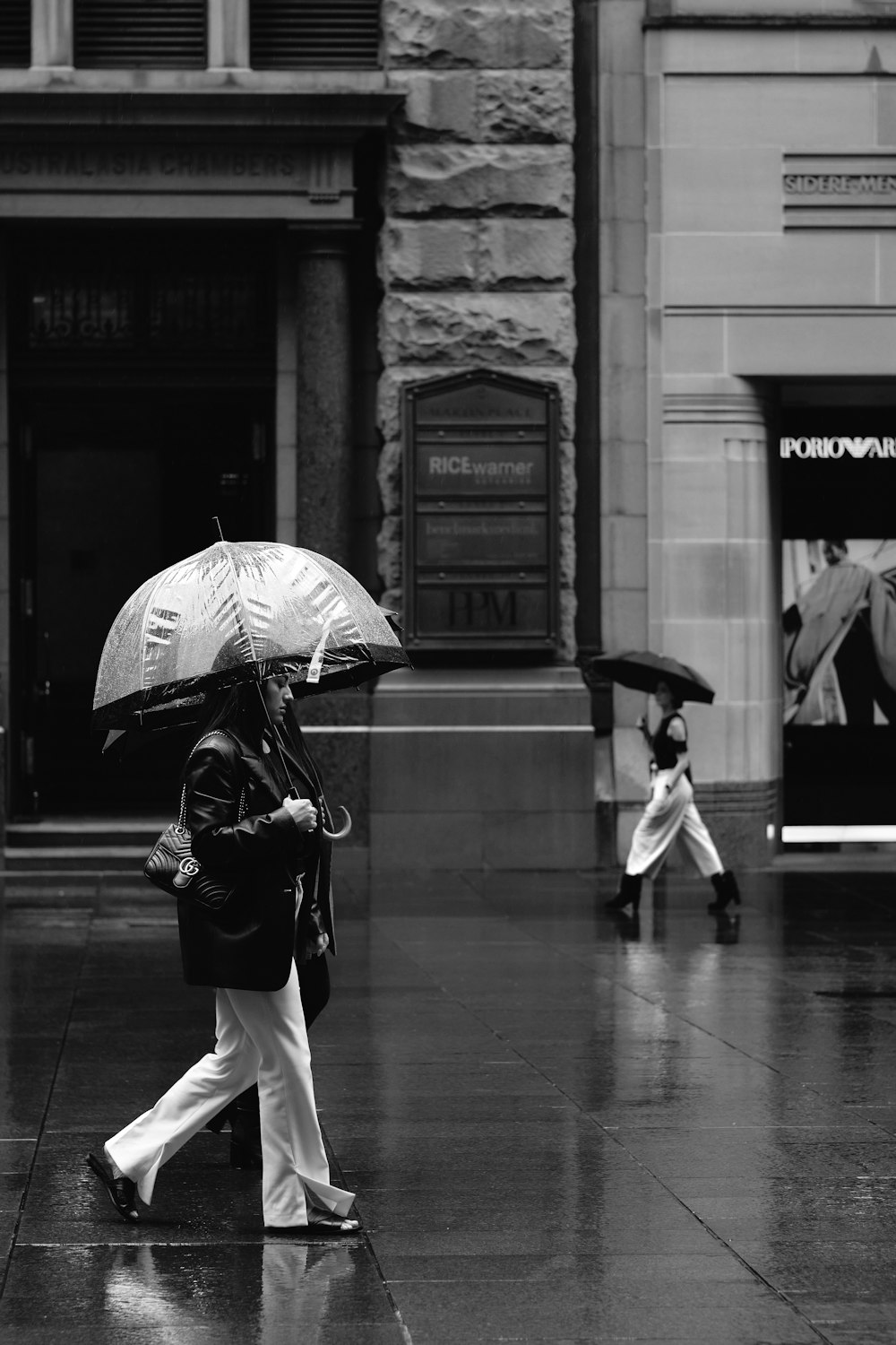 grayscale photo of man holding umbrella