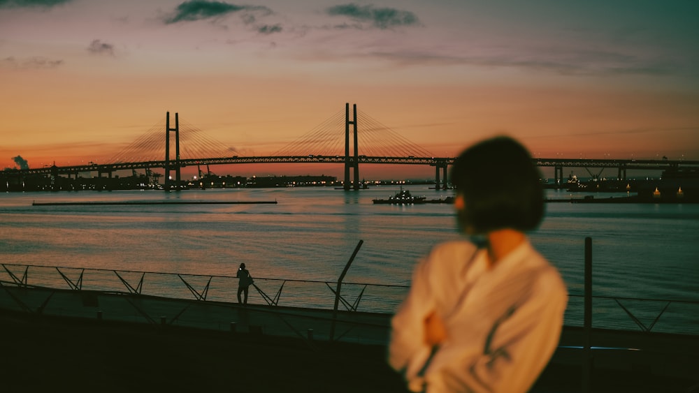 man and woman standing on dock during daytime