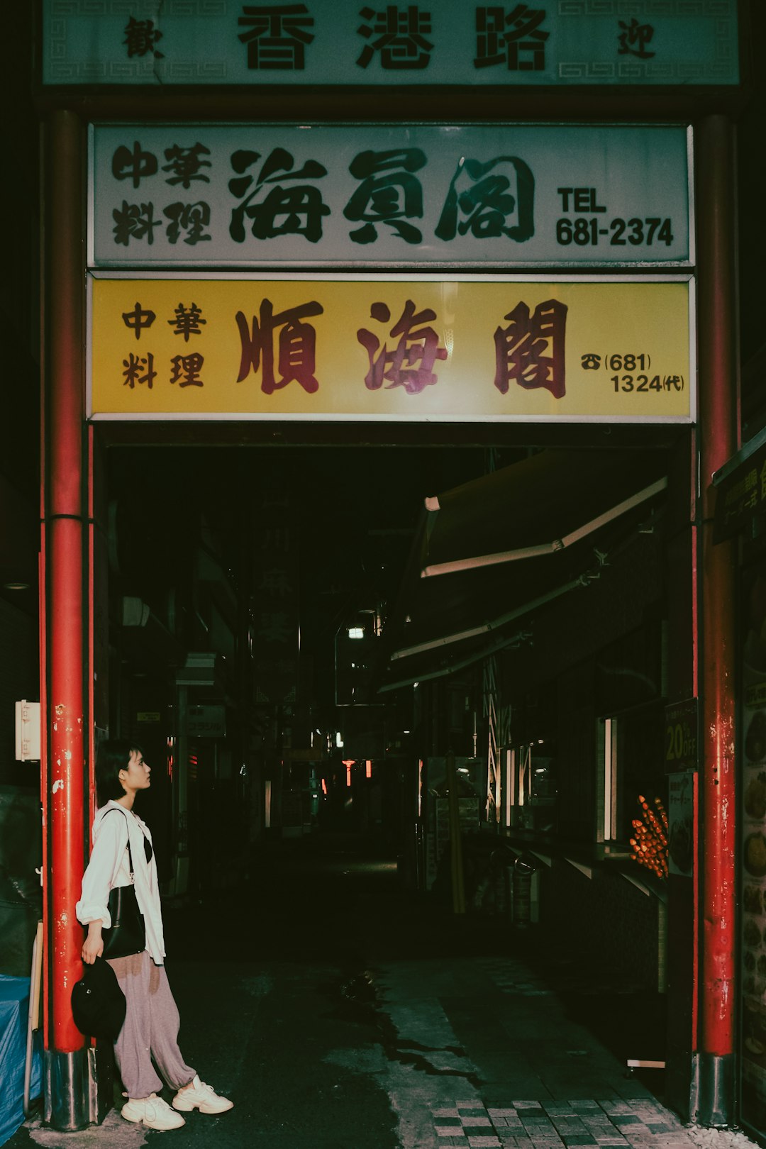 man in white dress shirt walking on street during nighttime