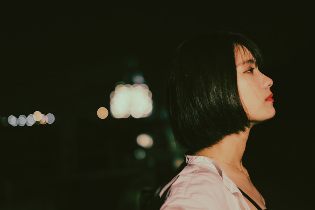 woman in white shirt looking at the light