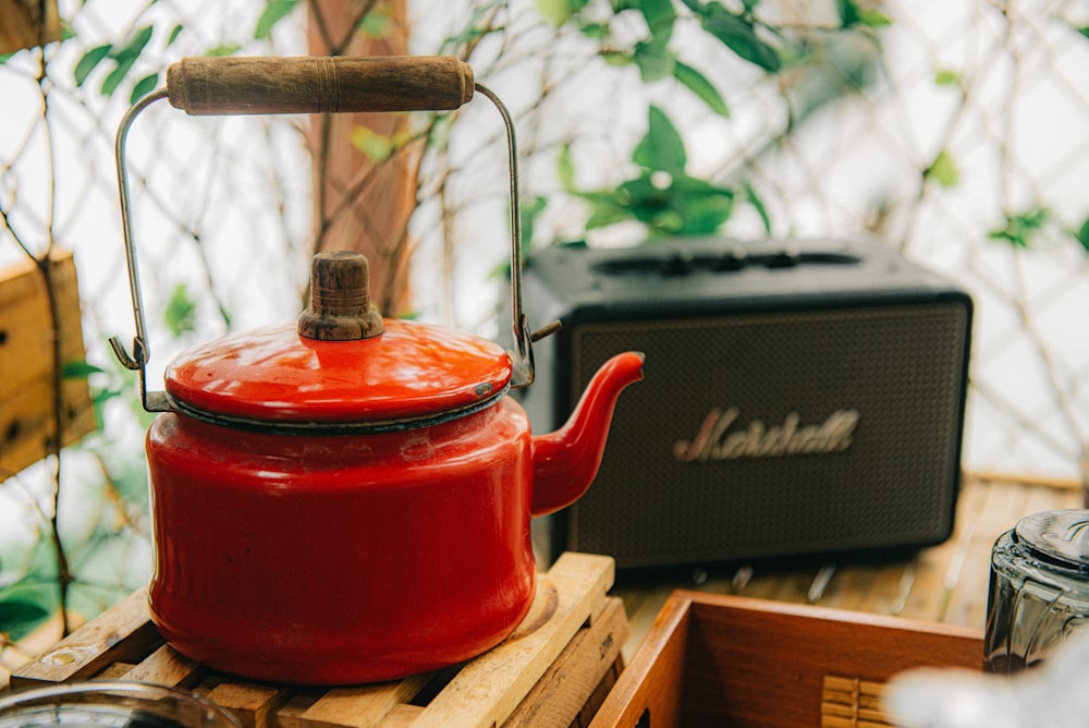 red kettle on brown wooden table