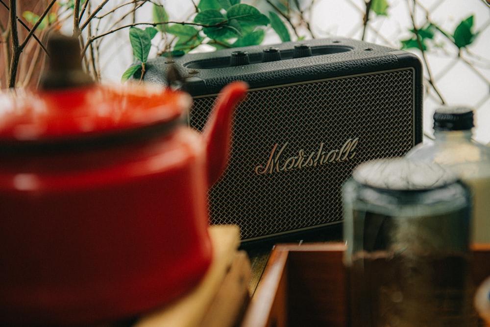 a radio sitting on top of a table next to a potted plant