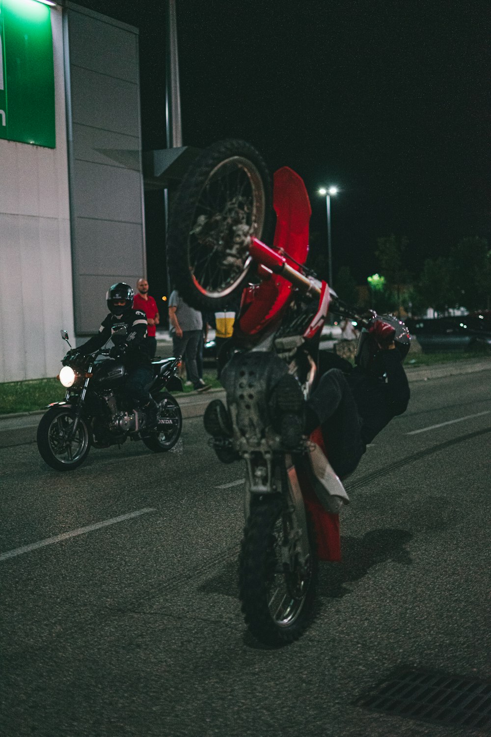 people riding motorcycle on road during nighttime