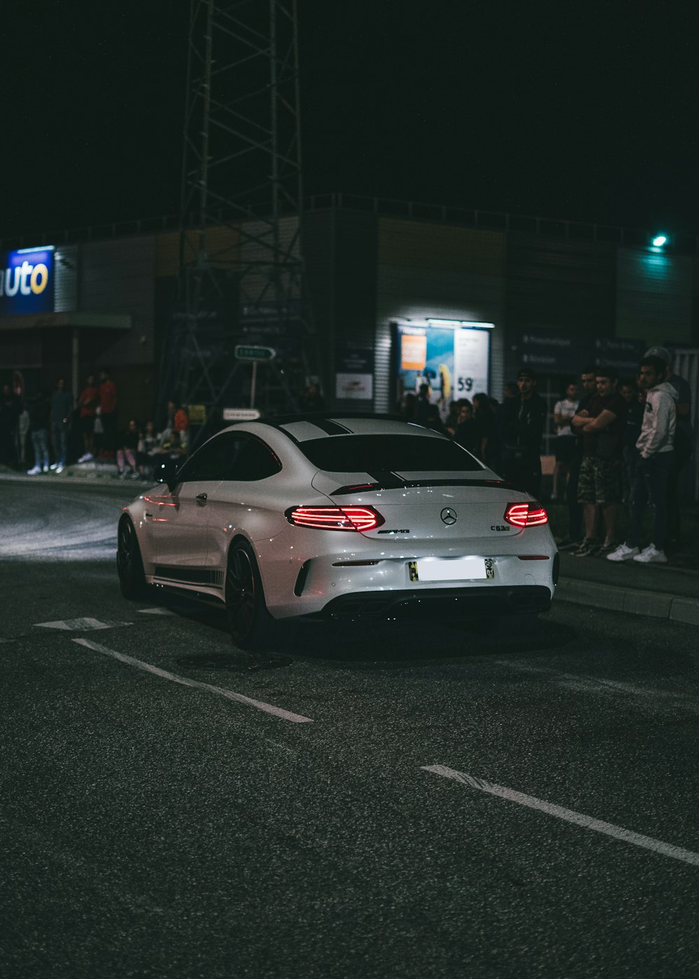 white bmw m 3 parked on street during night time