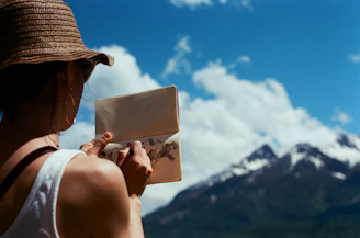 man wearing brown hat holding white card