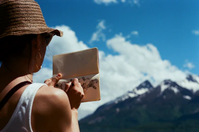 man wearing brown hat holding white card